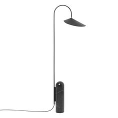 a black floor lamp on a white background with a cord attached to the light fixture