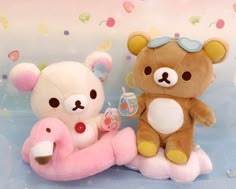 two teddy bears sitting next to each other on a blue background with confetti