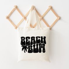 Looking for a cute tote bag to carry all your essentials this summer? This cute Beach Bum Palm Tree bag will be perfect to add to your collection. Perfect for a day at the beach or every day life! Trendy Beach Weekend Bags, Trendy Bags For Weekend Beach Season, Trendy Beach Season Weekend Bags, Cute White Beach Bags, Cute White Bag For The Beach, Fun White Beach Bag For Vacation, Beachy Weekend Tote Bag, Fun White Beach Bag, Fun White Beach Bags