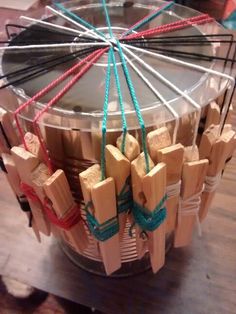 a spinning wheel made out of wooden blocks and stringing on top of a table