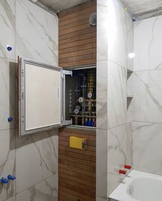 a bathroom with white marble walls and wood trim