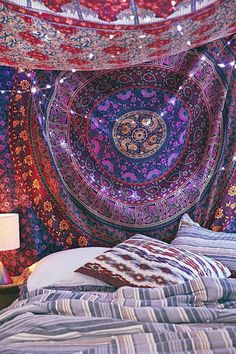 the bed is covered with an intricate tapestry