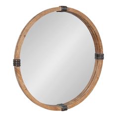 a round wooden mirror with metal accents