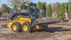 a yellow tractor is parked in the mud