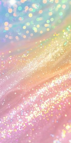 an abstract background with many different colors and sparkles on it, including pink, blue,