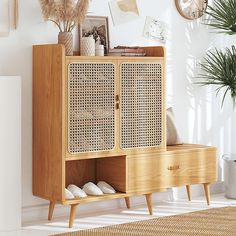 a wooden cabinet sitting next to a potted plant