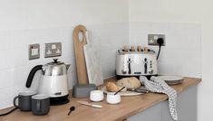 the kitchen counter is cluttered with cooking utensils