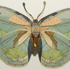 a paper butterfly is sitting on top of a map