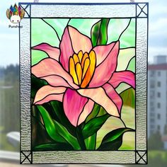 a stained glass window with a pink flower on it