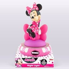 a minnie mouse figurine sitting on top of a pink object