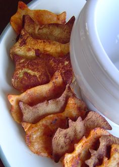 some fried food is on a plate next to a container