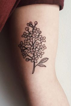 a black and white flower tattoo on the leg