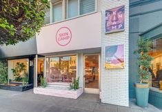 the store front of sun camp with plants outside