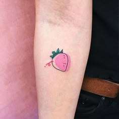 a small strawberry tattoo on the left arm