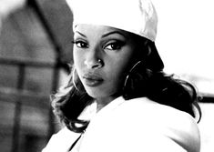 a black and white photo of a woman wearing a chef's hat with her hand on her hip