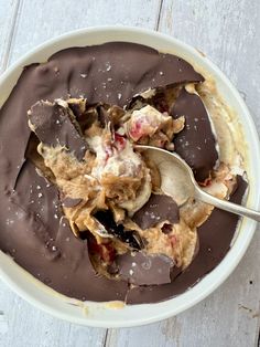 a white bowl filled with chocolate covered dessert