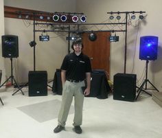 a man standing in front of some speakers