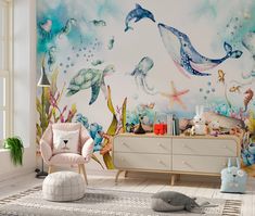 a child's room with a wall mural featuring sea animals and marine life on the walls