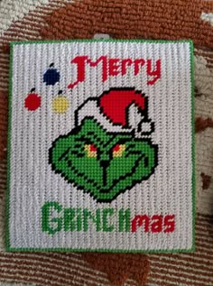 the grinch christmas ornament has been embroidered on it's back side