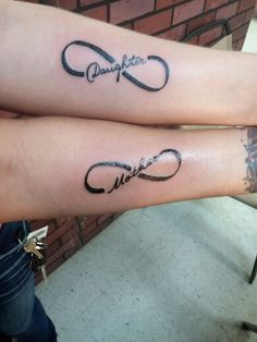 two people with matching tattoos on their arms, both have the words together and are holding hands