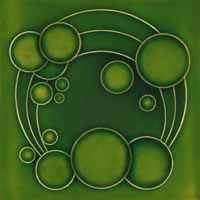 a green tile with circles and bubbles in the shape of a circle on top of it