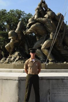 a man standing in front of a statue