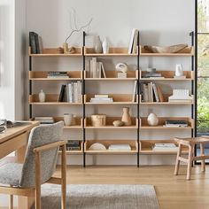 a living room filled with lots of wooden shelves