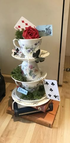 a stack of plates with flowers and cards on them