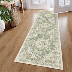 a large rug is on the floor in front of a door with potted plants