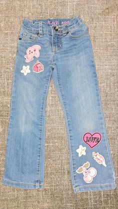 a pair of jeans with stickers on them