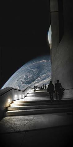 some people are walking up some stairs at night with the earth in the background and lights on