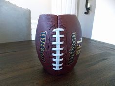 a football sitting on top of a wooden table