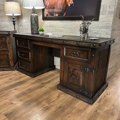 an office desk with two drawers and a horse painting on the wall in the background