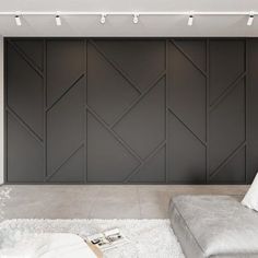 a modern living room with white and gray decor on the walls, carpeted floor