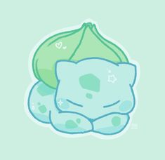 a blue and green pillow sitting on top of a light green background, with a heart shaped pillow next to it