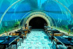 an underwater restaurant with tables and chairs