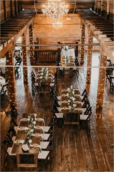 an overhead view of tables and chairs in a large room with chandelier hanging from the ceiling