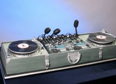 two turntables sitting on top of a suitcase