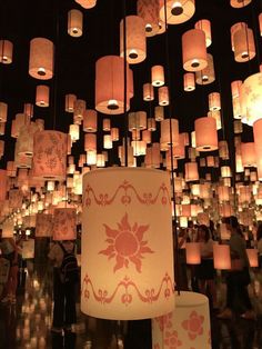 many paper lanterns are hanging from the ceiling