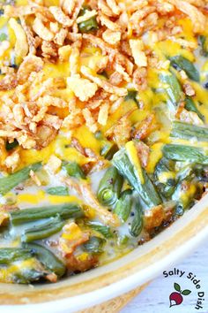 a casserole dish with green beans, rice and other toppings on top