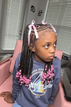 This cute crocheted hairstyle showcases neatly cornrowed hair that flows into long, box-braided extensions, providing a protective and fashionable choice for little ones. The braids are adorned with pink beads at the ends, adding a playful pop of color and a charming touch that kids will adore. Finishing the look, light pink ribbons are - Click to see more of 21 Fun and Creative Crochet Styles for Kids and follow us for more hairstyle ideas. // Photo Credit: Instagram @_braidsbyarmonnie_ Cute Braided Hairstyles With Extensions, Braiding Hair Styles For Kids, Natural Hair Styles With Braids Kids, Box Braids Hairstyles For Black Kids, Kids Hairstyles Back To School, Kids Stitch Braids Hairstyles, Kids Fulani Braids With Beads, Box Braids Toddler Girl, Hair Styles With Beads Kids