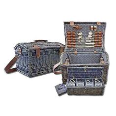 two wicker picnic baskets with utensils in them, one is blue and the other has brown handles