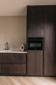 a kitchen with wooden cabinets and white counter tops