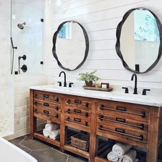 a bathroom with two mirrors above the sinks