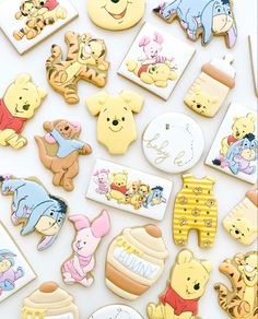 winnie the pooh and friends cookies are arranged on a white surface with various pictures