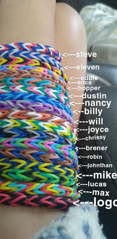 a close up of a person's arm with different colored bracelets on it