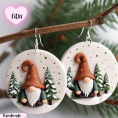 the earrings are decorated with gnomes and pine trees