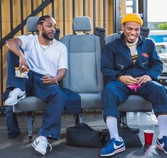 two young men sitting next to each other on a bench