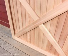 a close up of a wooden door on a building with wood planks and slats