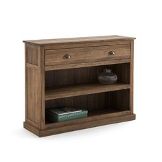 a wooden shelf with two drawers and a book